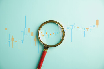A trader's keen eye for opportunities, as they holdmagnifier glass to scrutinize bar graph's...