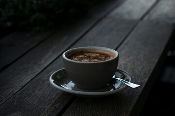 cup of coffee on a wooden table