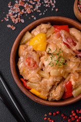 A delicious dish consisting of slices of chicken, sweet peppers and onions