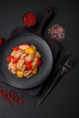 A delicious dish consisting of slices of chicken, sweet peppers and onions