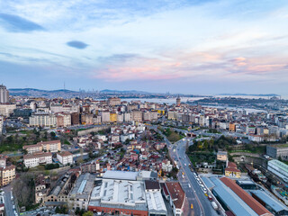 Aerial panoramic view of old urban borough at dusk. Famous historic Galata Tower and water in...