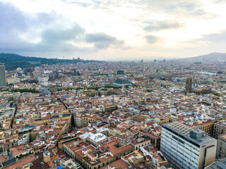 Fototapeta na wymiar Aerial panoramic view of historic quarter of metropolis. Buildings and narrow aisles in large city at dusk. Barcelona, Spain