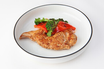 Grilled chicken with grilled vegetables on white background. Dietary grilled chicken meat.Isolated object. Copy space.