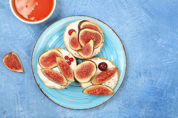 Ricotta,figs and bruschetta with honey on blue marble.Fresh sandwiches and toast with cream...