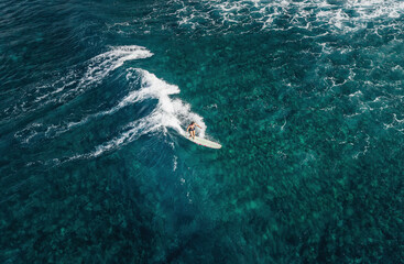 Surfer girl on a wave in Hawaii longboard surfboard