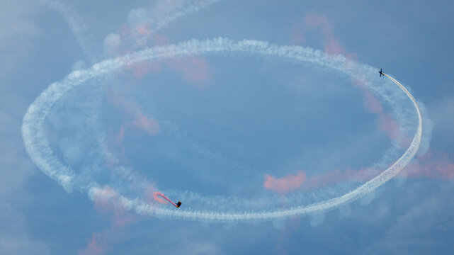 An airplane and skydiver circling the sky!