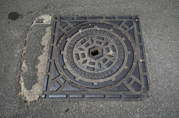 Square iron manhole cover in Les Andelys, France.