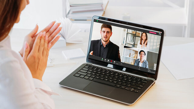 Video connection. Group call. Remote job. Diverse business men women team greeting celebrating successful cooperation applauding on laptop screen at office workplace.