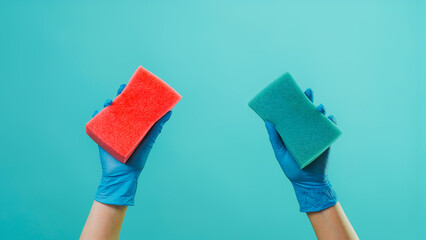 Surface washing. Dirt wiping. Kitchen cleaning polish sponges tools in houseworker hands in protective gloves isolated on green background empty space. - obrazy, fototapety, plakaty