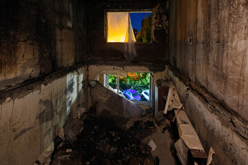 Burnt and collapsed apartment house interior. Consequences of war and fire