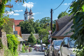 Old street with thatched roof houses in Tihany village in Hungary, tourist attraction over Balaton lake