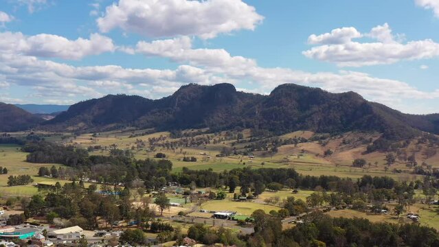 Gloucester town in scenic valley at Barrington tops mountain ranges aerial 4k.
