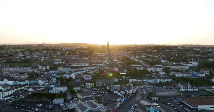 The city of Tramore at sunset. The camera flies towards the setting sun 4k