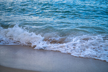 Turquoise Blue Wavers on Tan Sand with White Water.