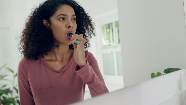 Dental, bathroom mirror or woman brushing teeth with toothbrush, toothpaste and home morning routine. Reflection, self care or person cleaning mouth, gum or plaque for oral shine, hygiene or wellness