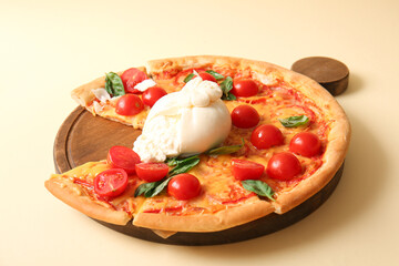Wooden board of tasty pizza with Burrata cheese on yellow background