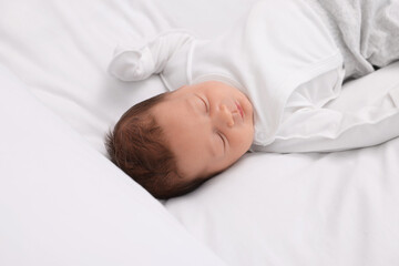 Fototapeta na wymiar Cute newborn baby sleeping on white bed
