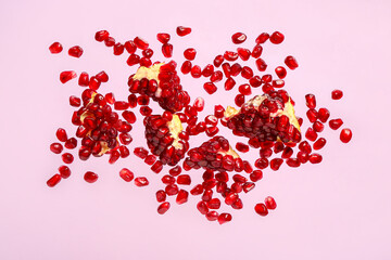 Flying fresh pomegranates with seeds on lilac background