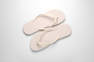 Stylish flip flops on white background, top view