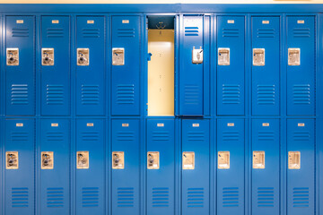 Single open empty blue metal locker along a nondescript hallway in a typical US High School. No...