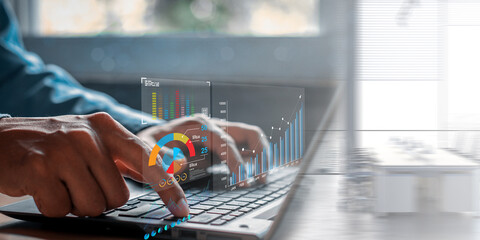 Data analyst working on business analytics dashboard with charts, with KPI and metrics connected to the database for technology finance, operations, sales, marketing