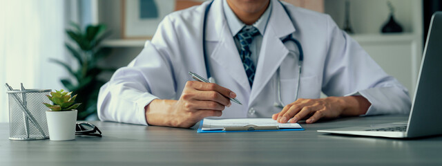 Doctor carefully review detailed medical report with laptop and diagnosing illness for effective...