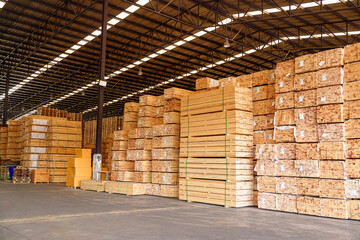 Stock of wooden planks manufacturing Factory in industry. Stacks with pine lumber, wood harvesting shop, Stacked wooden boards for construction.