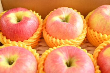beautiful pink apple in yellow wrap bubble, healthy fruit in the box
