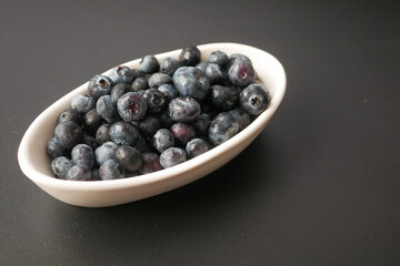 Close up of fresh blue berry in a bowl on table 