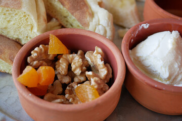 walnut and peach fruit in a small bowl on table 