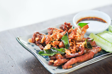 deep fried pork , belly of pork or pork or fried pork with cucumber and spicy sauce