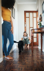 Dog, house and happy lesbian couple play, bonding or having fun together. Pet, gay women smile with animal in hallway and care in healthy relationship, love connection and lgbt people in home