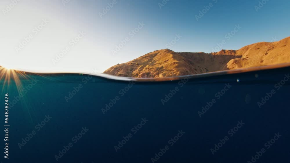 Poster underwater splitted view of the calm sea and famous komodo island in the komodo national park at sun