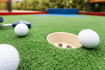 Golf ball and Golf Club on Artificial Grass.