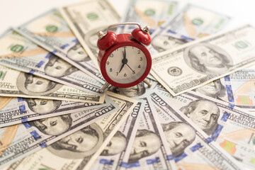 alarm clock and dollars time is money