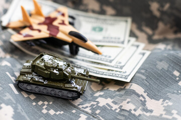 Tank on dollar banknotes. The concept of war costs, military spending, economic crisis