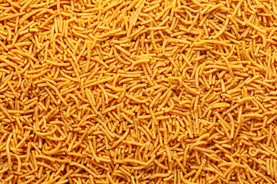 Nimbu masala besan sev Indian namkeen (snacks) Full-Frame Background. Top View.