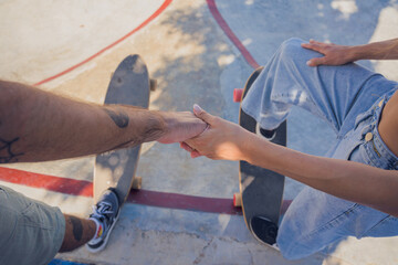 Young happy couple with skateboards enjoy longboarding at the skatepark © romaset