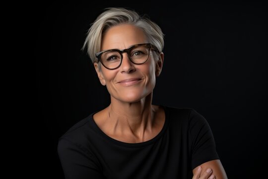 Portrait Of A Middle-aged Woman In Glasses On A Black Background