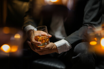 businessmen holding a glass of whiskey
