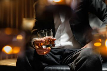 businessmen holding a glass of whiskey