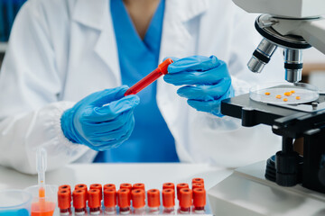 Modern medical research laboratory. female scientist working with micro pipettes analyzing...