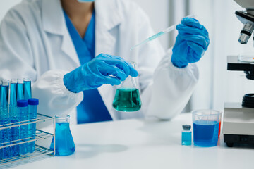 Modern medical research laboratory. female scientist working with micro pipettes analyzing...