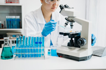 Modern medical research laboratory. female scientist working with micro pipettes analyzing...