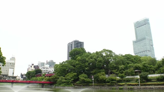 OSAKA, JAPAN - JULY 2023 : View of Abeno Harukas building and Tennoji park at Abeno ward. Daytime time lapse shot. Travel and tourism concept video.