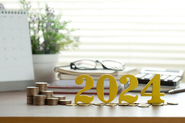 Word 2024 put on coins with coins stacked on the desk. Savings and Investment New Year...