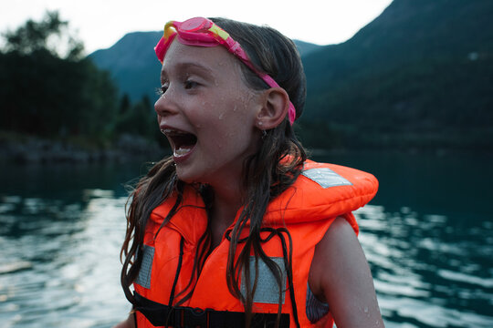 girl laughing after swimming in a Norwegian Fjord