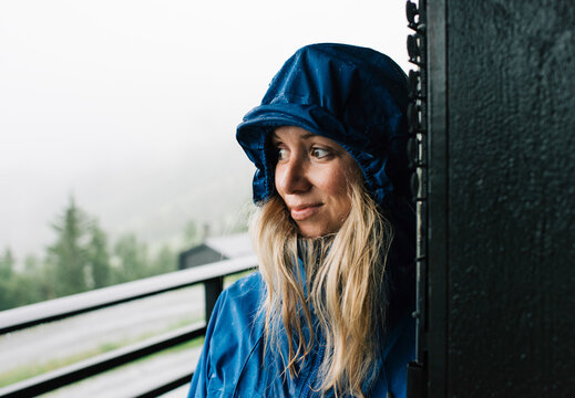 portrait of a woman stood in a doorway in a raincoat in Norway