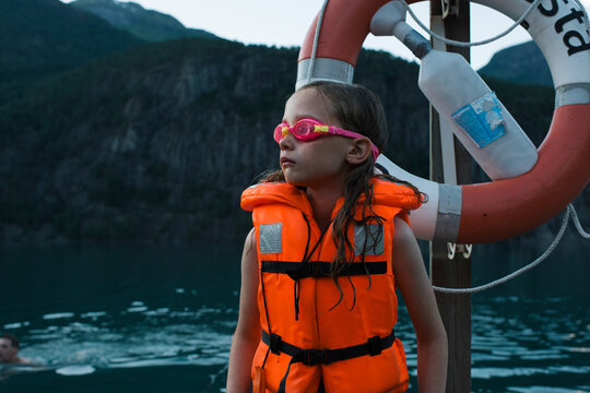 girl looking very cold waiting to swim in the sea in Norway