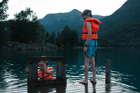brother and sister swimming and jumping into a Fjord in Norway